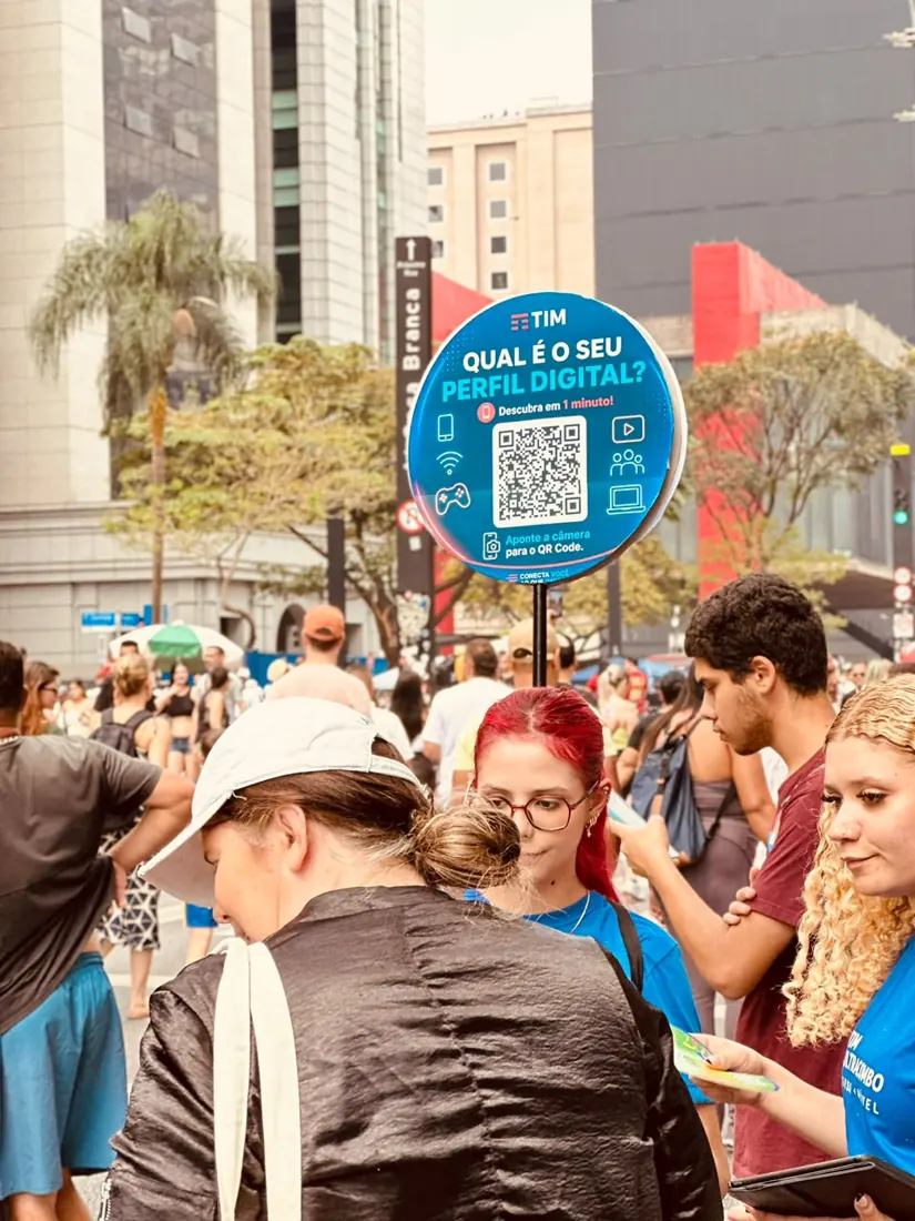 Placa do quiz TIM com QR Code no meio do público da Avenida Paulista